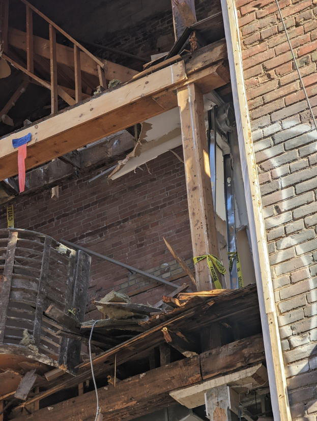 Teilweise demoliertes Gebäude mit verstreuter Trömmerschutt, zerbrochene Fenster und Türen nach Abriss.