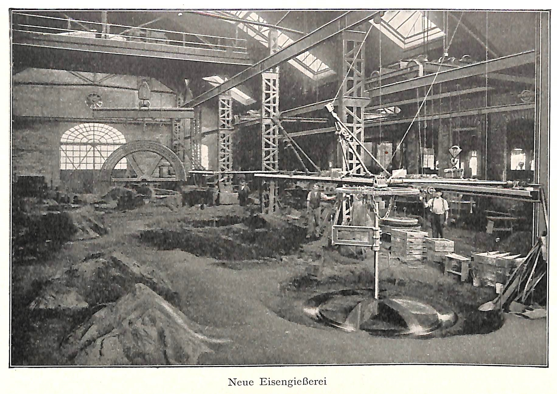 Ein altes Schwarz-Weiß-Foto einer Fabrik mit Arbeitern, die an einer Maschine arbeiten, umgeben von Metallstangen und -pfosten, mit dem Text "Neue Eisengießerei, die erste Fabrik in Deutschland" unten.