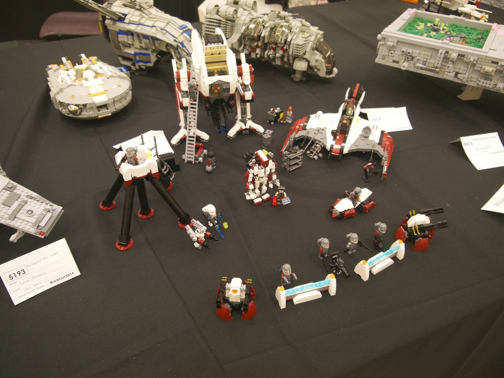 Ein Tisch mit verschiedenen Gegenständen darauf, umgeben von weißen Papieren auf beiden Seiten.