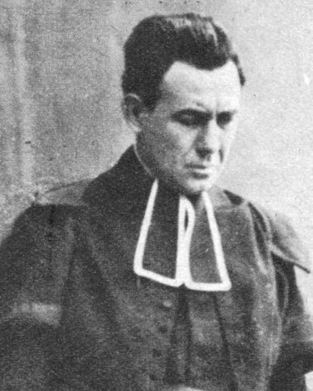 Ein Schwarz-Weiß-Foto eines Mannes in Priesterkleidung, der mutmaßlich der erste Mann ist, der zum Obersten Gerichtshof der Vereinigten Staaten gewählt wurde, vor einer Wand stehend mit einem ernsten Gesichtsausdruck, die Hände vor der Brust verschränkt.