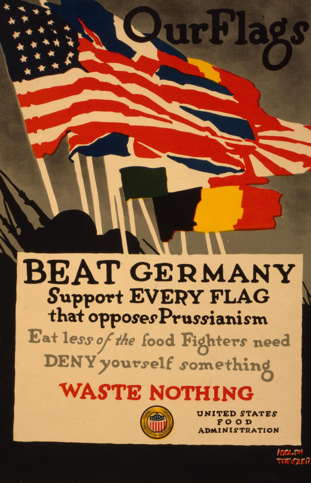 Ein Plakat mit einer roten, weißen und blauen Flagge mit einem weißen Stern, begleitet von fettem schwarzem Text, der "Unsere Flaggen schlagen Deutschland - Unterstützt jede Flagge, die gegen Preußentum kämpft" lautet, mit einem weißen Rand um den Text.